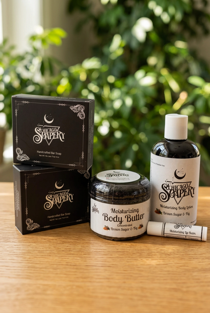 Brown Sugar & Fig gift box contents on a wooden table: two boxed handmade soaps, body butter, lotion, and lip balm